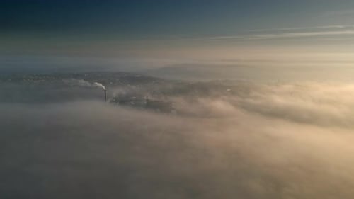 Industrial Cooling Tower in the Morning mist.Aerial scene with warm morning sunlight