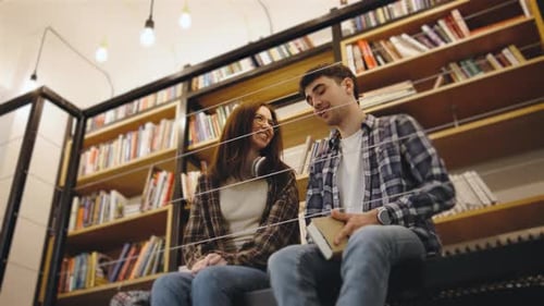 Couple Reading Book Together in Cozy Library