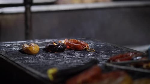 Street Food. Portuguese traditional spicy sausage being barbecued over hot charcoal fire