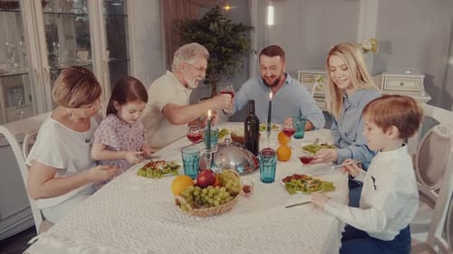 Family Celebration Toasting at Festive Dinner Table