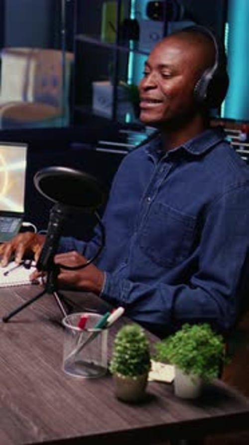 Vertical Video Influencer Records Podcast with Man Using Audio Recording Equipment in Home Studio