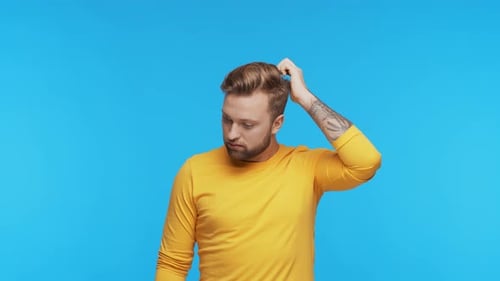 Thinking Young Man Over Vibrant Background Studio Portrait of Expressive Handsome Person