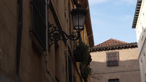 Historic street lantern and balconies in old Madrid Spain