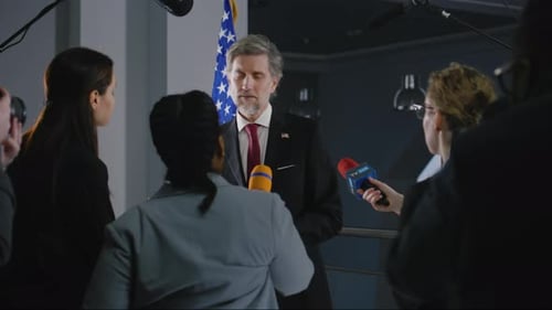 Politician Giving Press Conference to Eager Reporters