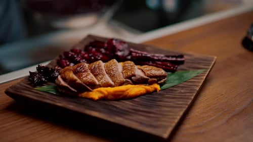 close-up of a dish pieces of juicy roasted duck with puree on a plate Asian cuisine restaurant