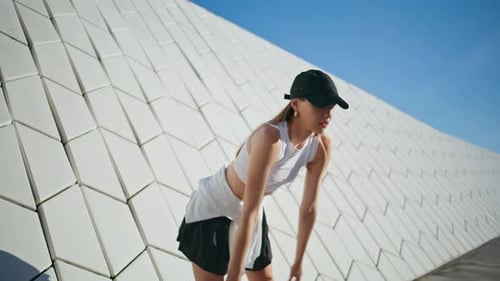 Young Woman Stretching Outdoors in Urban Setting