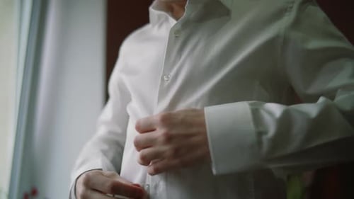 Close-up of Man Dressing Up and Fastening Buttons on Shirt at Home. Man Buttoning His Shirt. People
