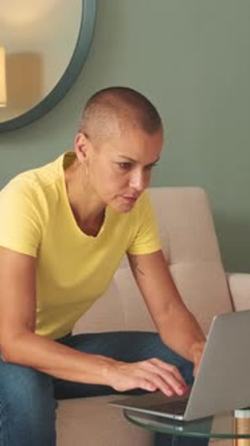 Woman Working On Laptop In Comfortable Home Setting