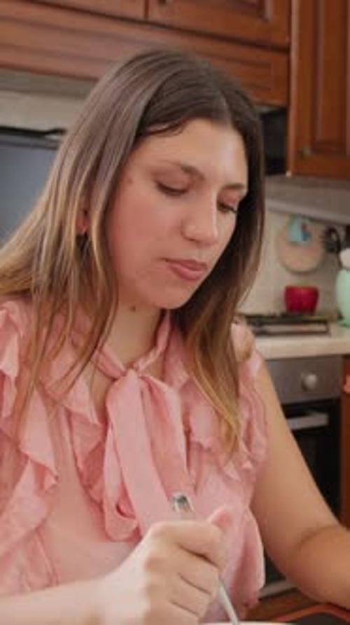 Woman Eats Lunch at Home in Portrait Orientation