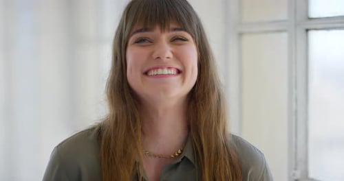 Cheerful Woman Smiling in Bright Indoor Setting
