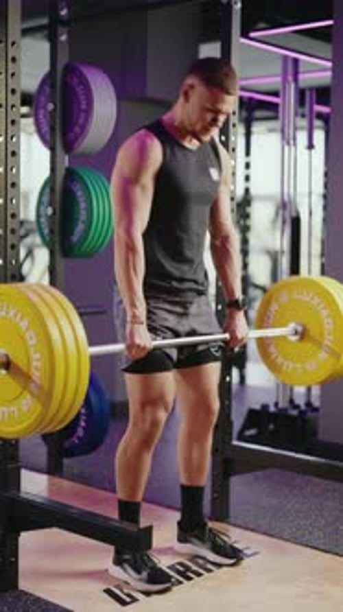 Muscular Man Performing Deadlifts in a Modern Gym