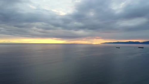 Calm Seascape With Sunset Hue In The Horizon. - aerial