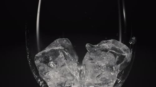 Ice Cubes Fill Glass on Dark Background
