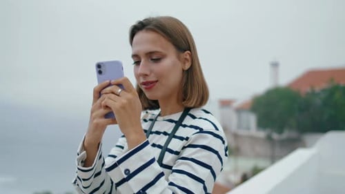Happy Millennial Taking Photos at Sea Town View