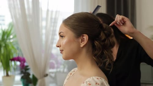 Woman Gets Hair Styled by Stylist in Salon