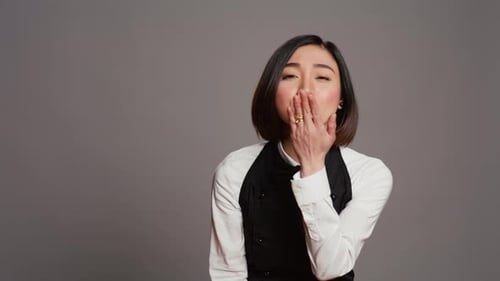 Cute Flirty Waitress Blowing Air Kisses in Front of Camera