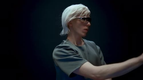Man Using Futuristic Interface in a Dark Setting