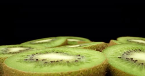 Juicy fresh kiwi fruit cut in half super close up high quality shoot fly over 4k shoot on dark backg