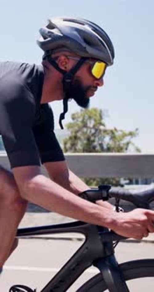 Exercise, man and cycling on bike in city for cardio workout, endurance challenge and pace training