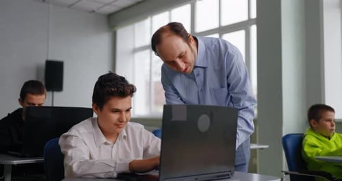 Computer Science Lessons In Middle School Teacher Helping To Teen Boy Student Programming Courses