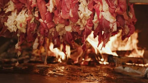 Meat Roasting over Open Flames for Food Preparation