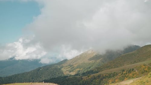 Mountainside Vista with Rolling Hills in Overcast Weather