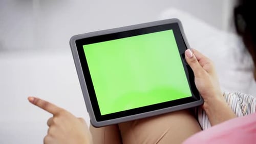 Woman Using Tablet with Chroma Key Screen
