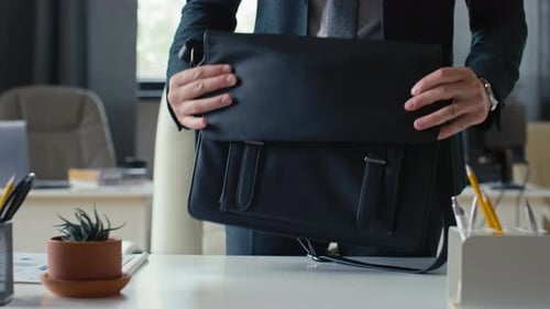 Man Removes Laptop and Tablet From Messenger Bag