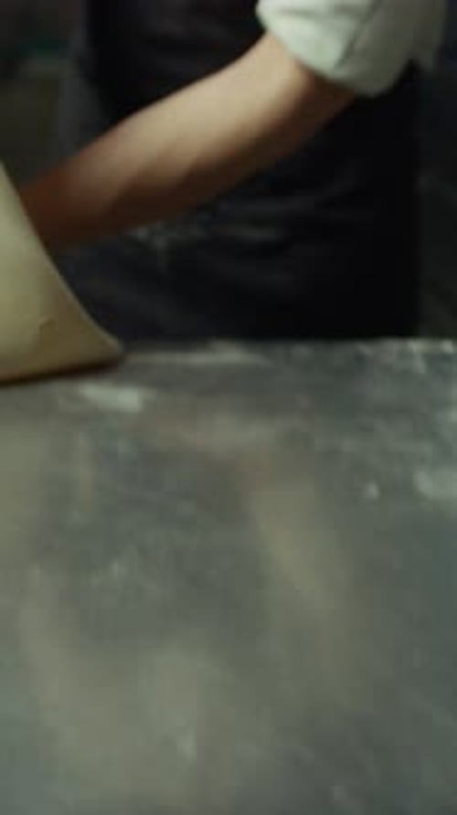 Chef Rolls Out Thin Pastry To Make Tortellini Bolognese In A Restaurant