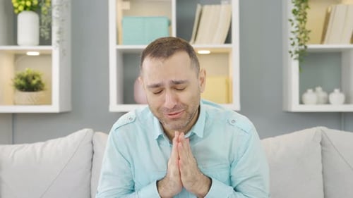 Man Pleading and Begging on Couch Indoors