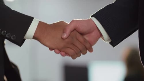 Cropped View of a Strong Handshake Two Businessmen Shake Hands After Signing a Contract Business