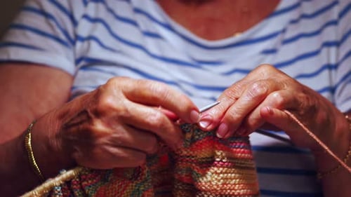 Senior Adult Knitting with Needles and Colorful Yarn