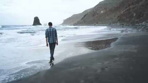 Young Man Tourist Walking on the Famous Volcanic Black Sand Beach Benijo in the North of Canary