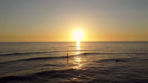 Standup Paddleboarding At The Mediterranean Sea During Beautiful Sunset In Lebanon. - aerial approac