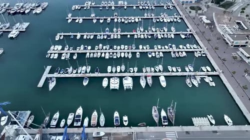 Drone shot flying over yachts and boats moored in a marina in Spain