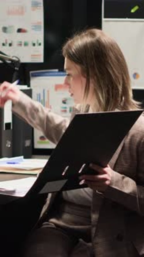 Vertical Video Officer Reviews Evidence in Office Space