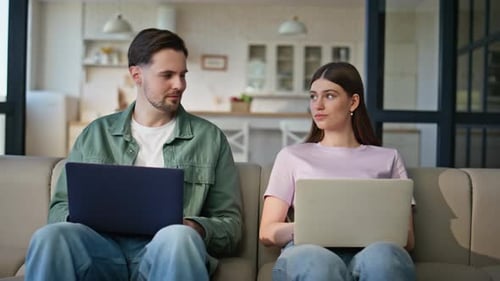 Home Sweethearts Browsing Laptops at Soft Couch Place Young Couple Working
