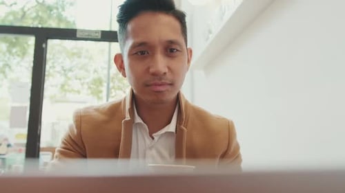 Man Working on Laptop in Urban Workplace