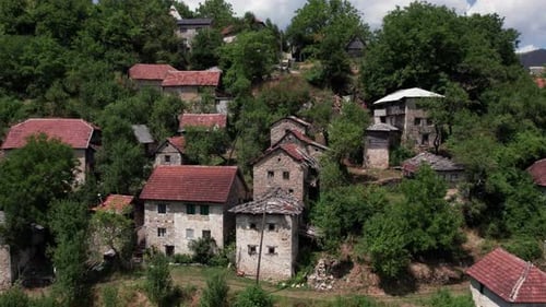 Drone footage of traditional stone houses in an old mountain village