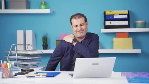 Man Experiencing Shoulder Pain in Office