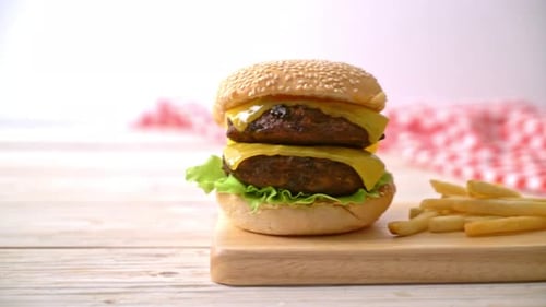 Appetizing Double Cheeseburger with French Fries on Board