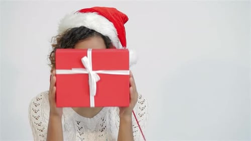 Woman in Santa Hat Holds Christmas Present