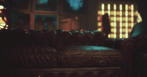 Vintage Leather Couch in a Cozy Lounge with Ambient Lighting at Night