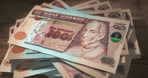 Guatemala quetzal money banknotes falling on the table