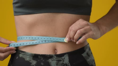 Unrecognizable Girl Woman Measure Waist Size Figure Body Shape with Measuring Tape Check Stomach