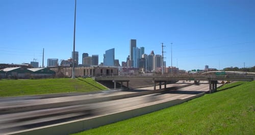 Bright sunny day I-10 East freeway timelapse of cars and downtown Houston, Texas