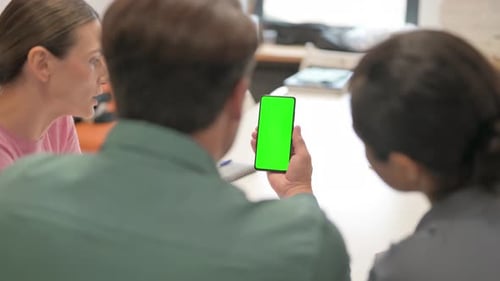 Multi Ethnic Team Using Phone with Green Screen