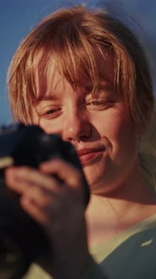 Young Adult Woman Taking Photos with Small Camera
