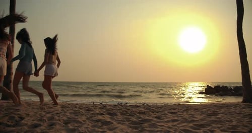 Women friends running enjoy life playing and freedom beach at sunset, Attractive together