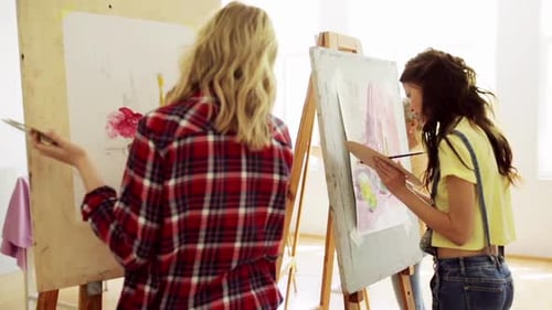 Art School Creativity and People Concept - Group of Students with Easels